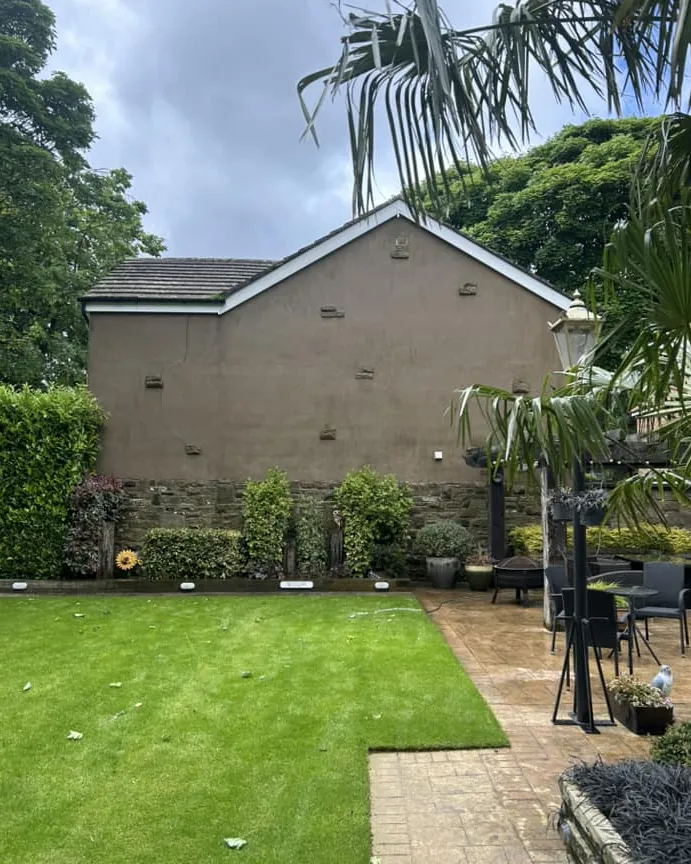 Back garden with lawn and patio