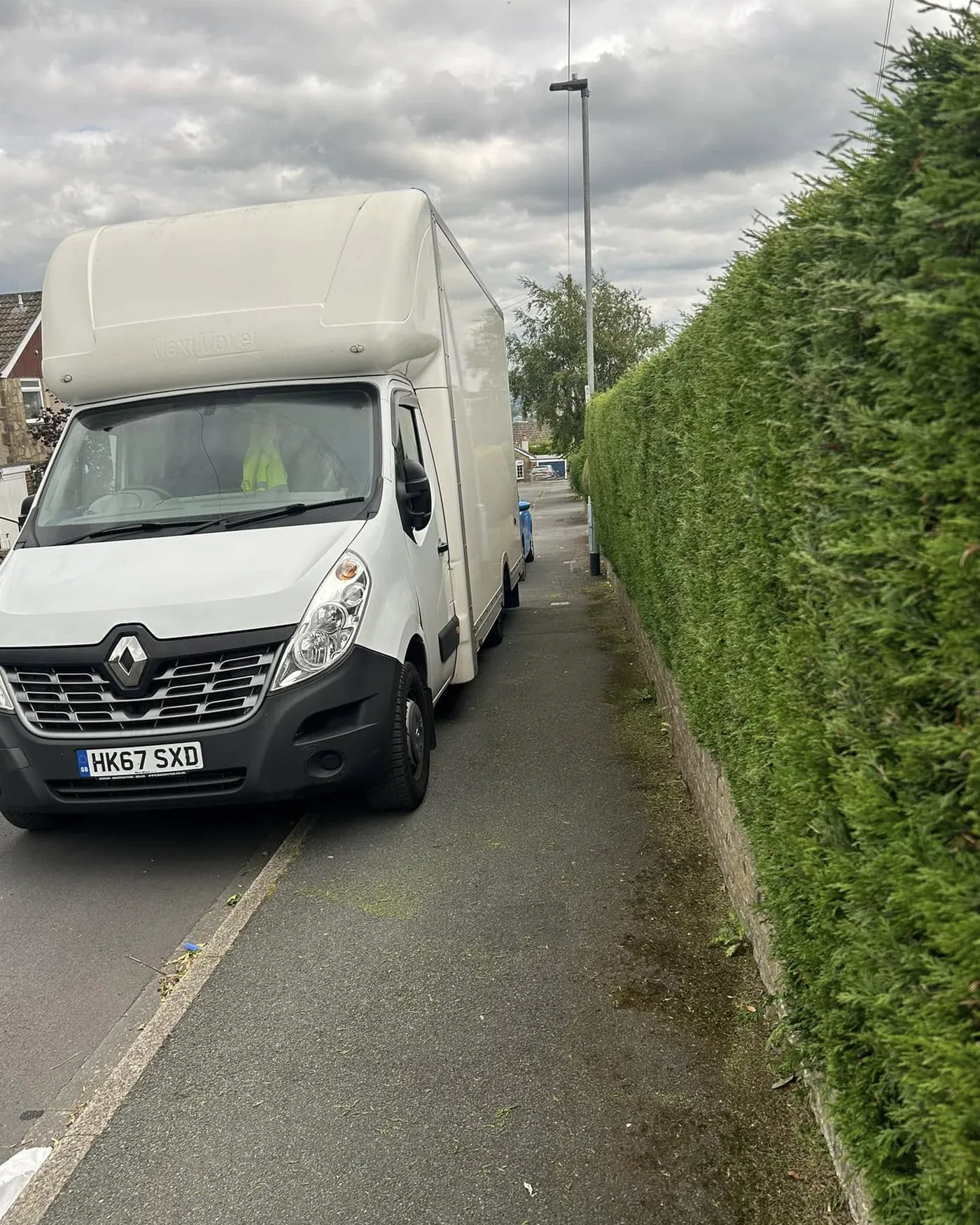 JKS van with trimmed hedge